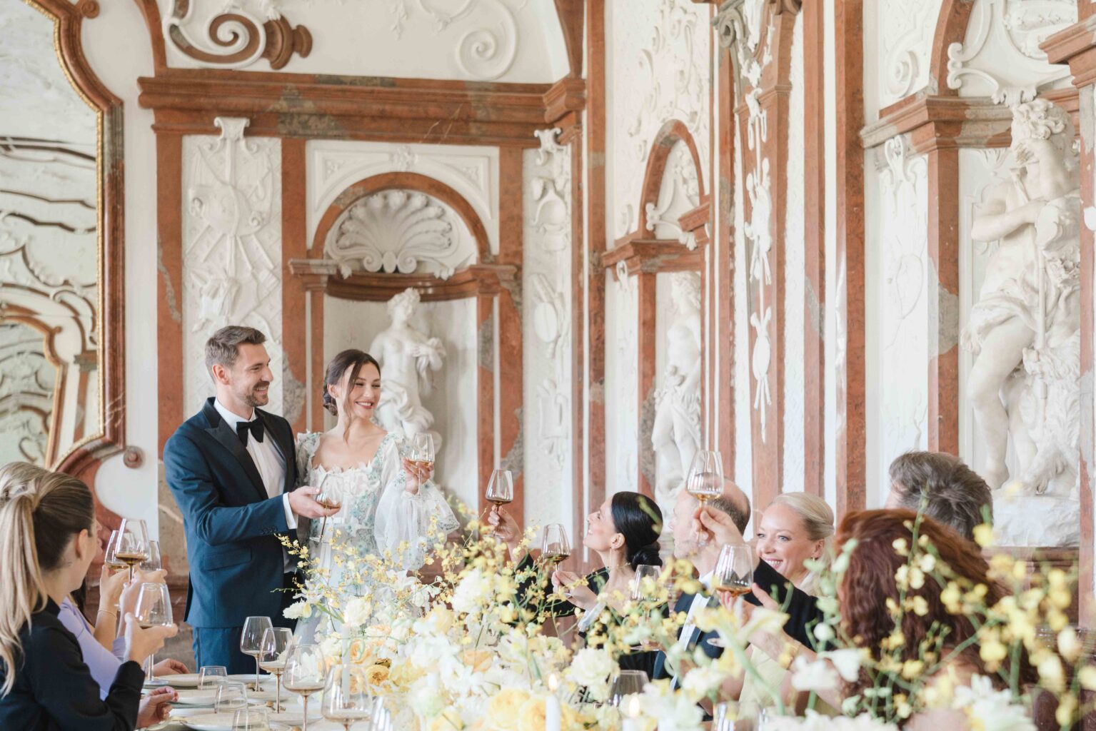 Hochzeit im Schloss Belvedere. Die Hochzeitsgäste stoßen mit Gläsern an